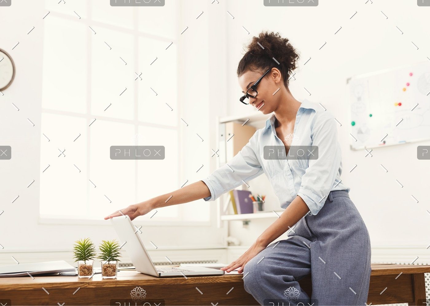 demo-attachment-184-business-woman-opening-laptop-at-office-PU4ZAGW