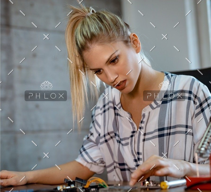 demo-attachment-36-woman-testing-circuit-board-in-her-office-8WM2R6N-croped